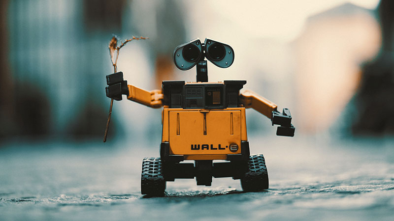 Small robot holding a twig with leaves