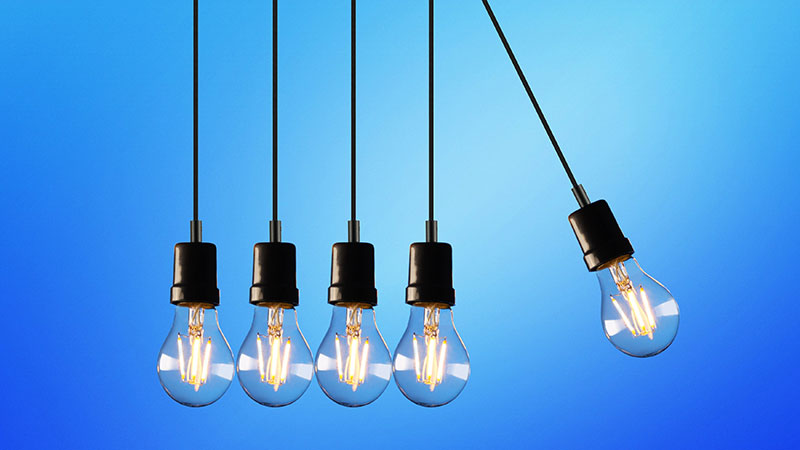 Five light bulbs arranged as Newton's cradle