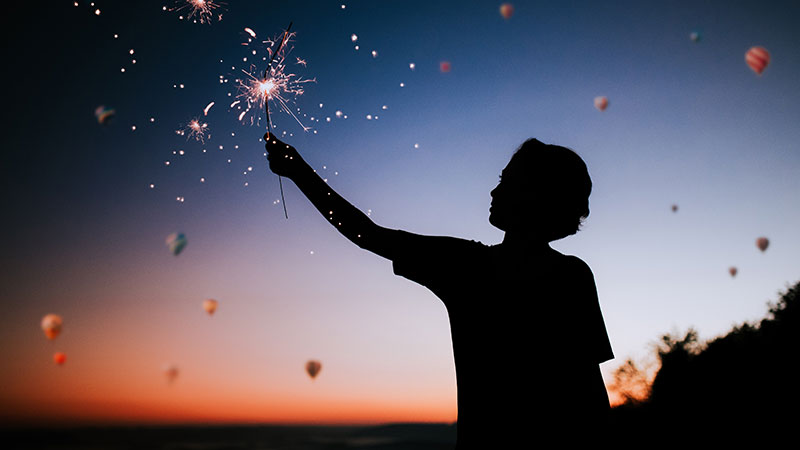 Silhouette Of A Person Holding A Sparkler