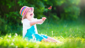 Child playing with a butterfly